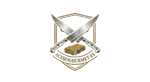 Logo de dos cuchillos cruzados y debajo una piedra de afilar y abajo el textoacero gourmet.es todo enmarcado en un escudo.Sin fondo y en color dorado